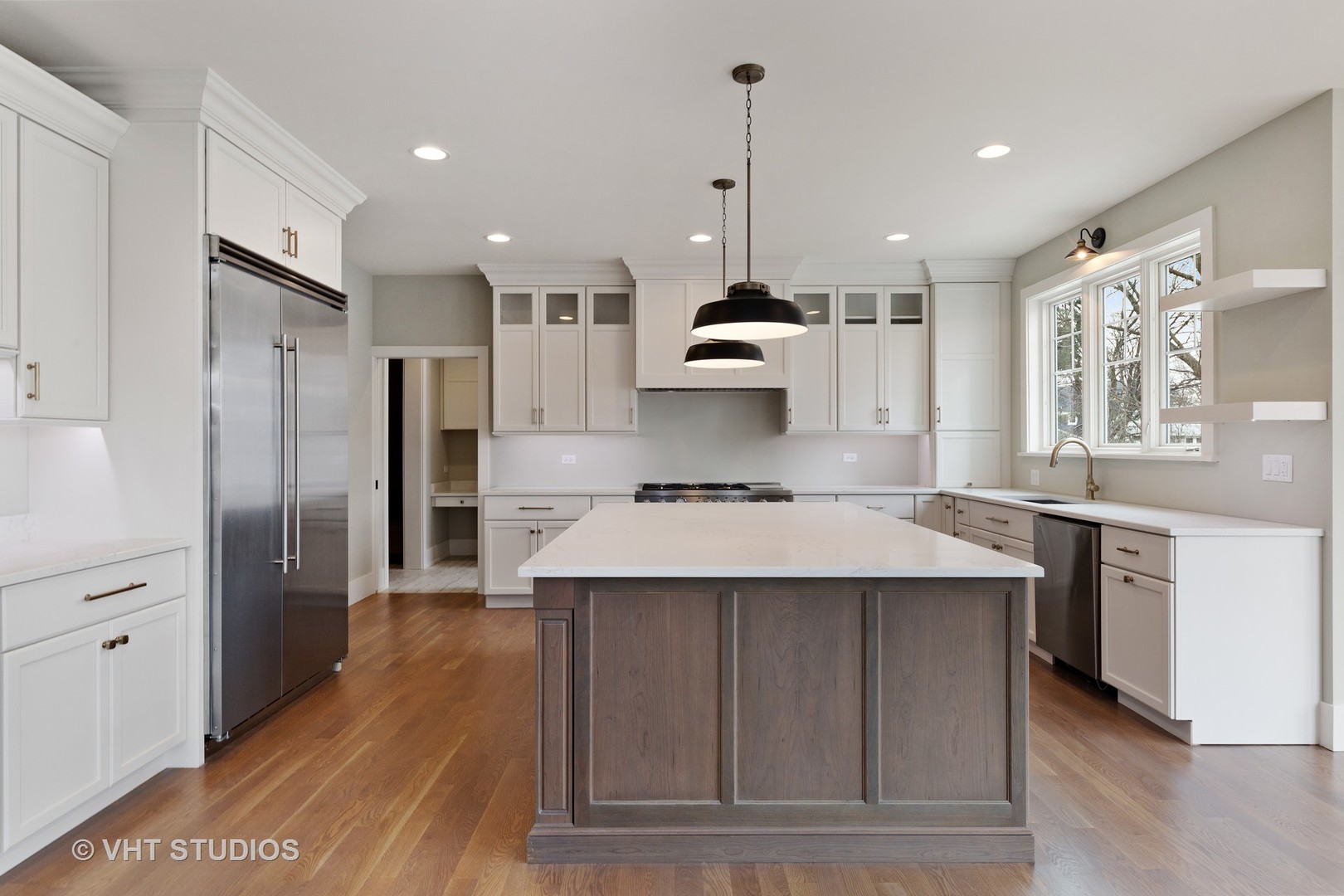 469 South Sunnyside Avenue Elmhurst, IL 60126 - Photo 4 of 37 a large kitchen with stainless steel appliances kitchen island a large counter top and a wooden floors