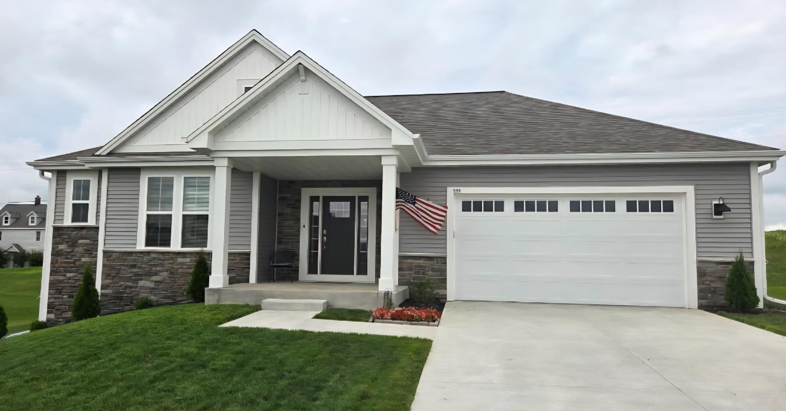 This home features a large lot, an inviting entryway, and well-maintained landscaping.