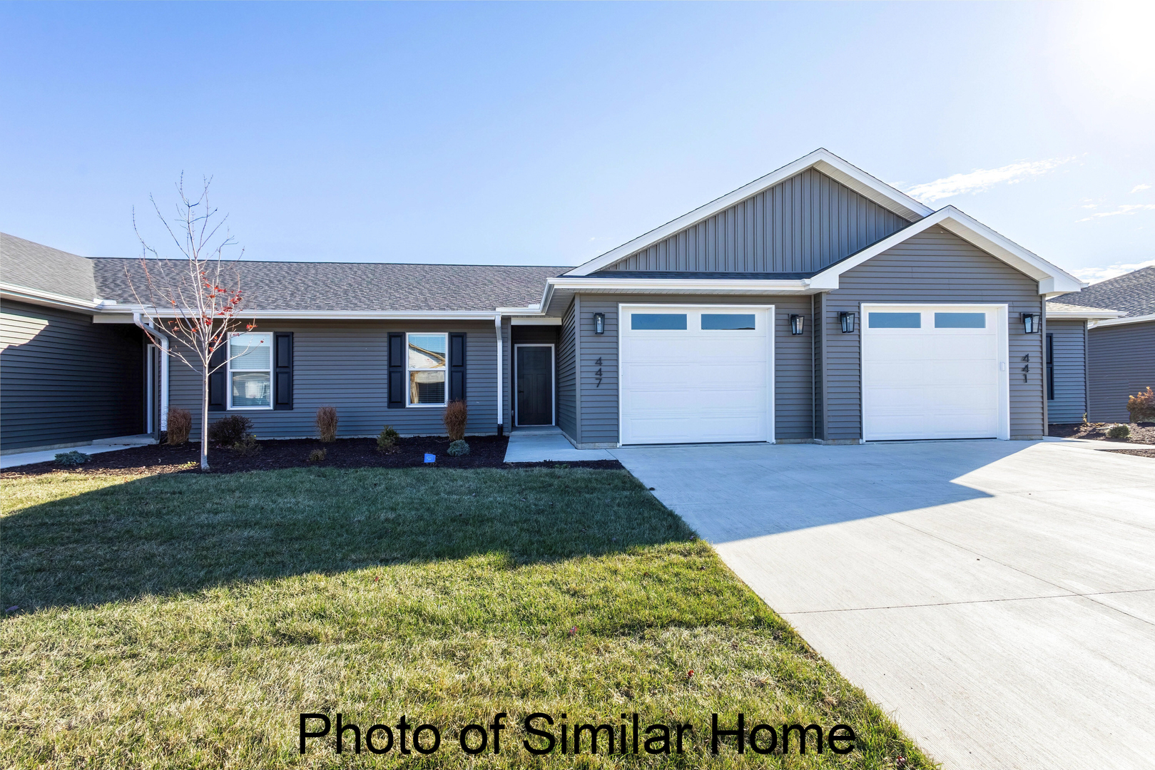 446 North 2nd Street Eldridge, IA 52748 - Photo 1 of 28 a front view of a house with a yard and garage