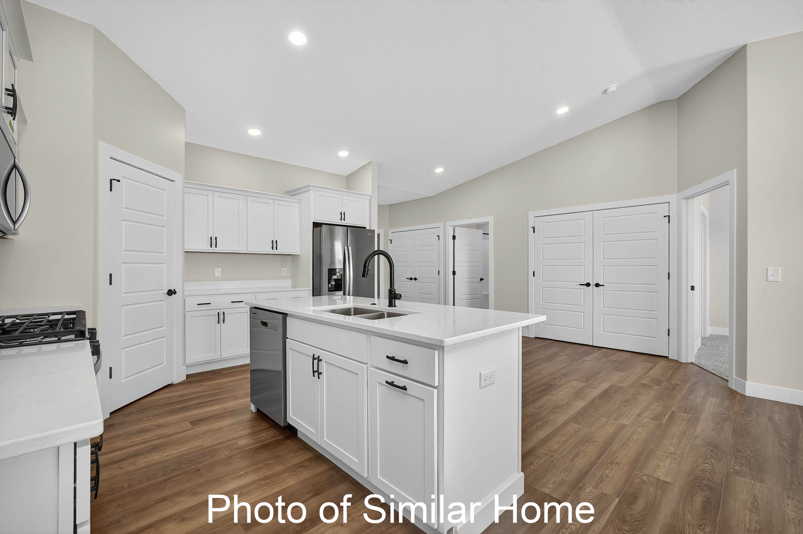 446 North 2nd Street Eldridge, IA 52748 - Photo 14 of 28 a kitchen with white cabinets appliances and wooden floor
