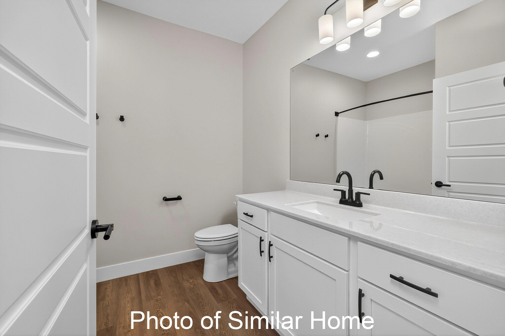 446 North 2nd Street Eldridge, IA 52748 - Photo 22 of 28 a bathroom with a granite countertop sink a toilet and a mirror