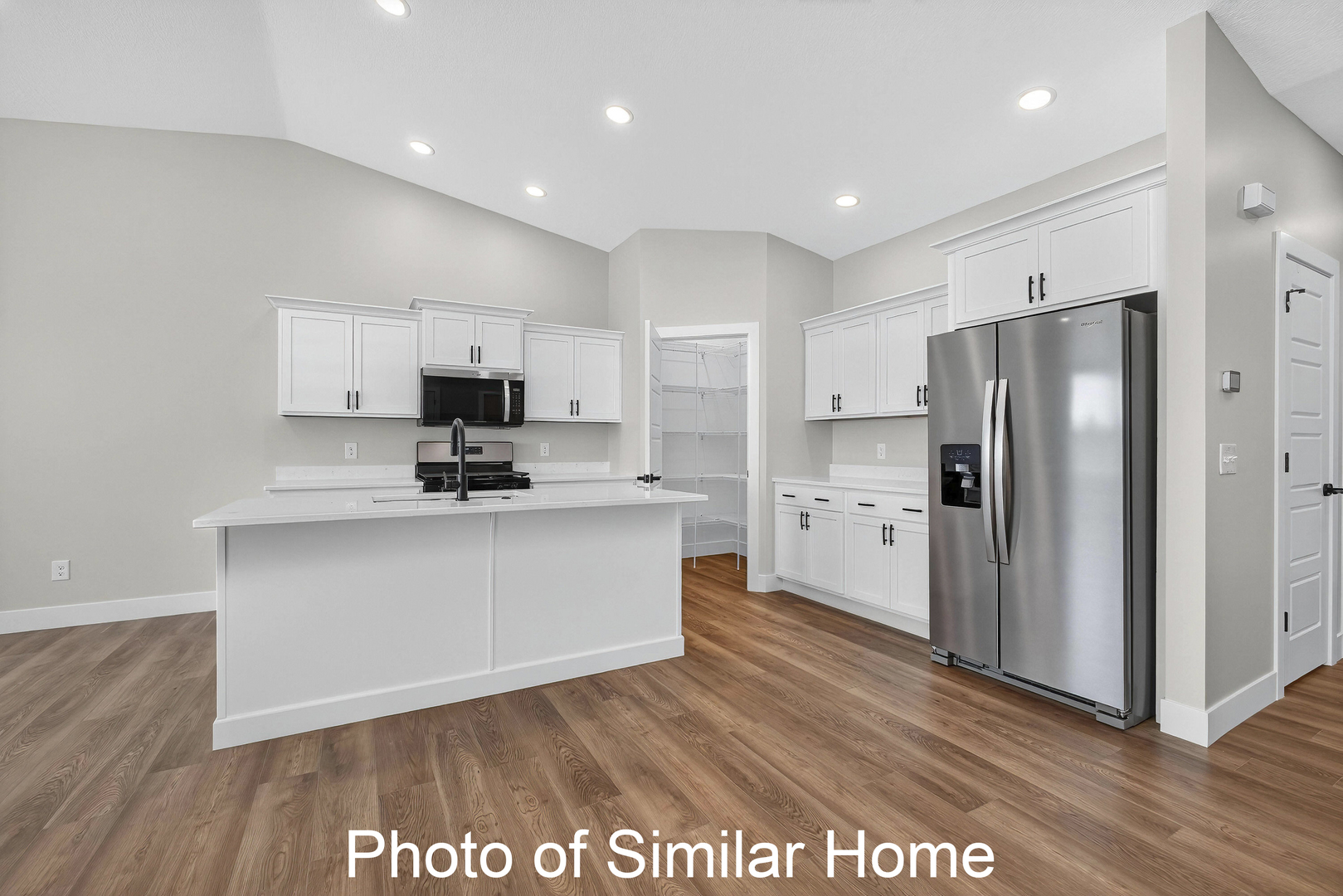 446 North 2nd Street Eldridge, IA 52748 - Photo 10 of 28 a kitchen with stainless steel appliances granite countertop a refrigerator sink and white cabinets