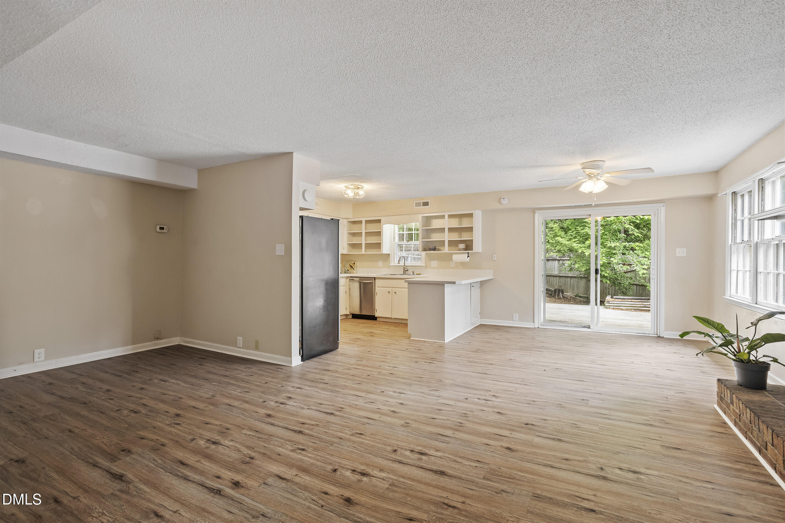 1801 Quail Ridge Road Raleigh, NC 27609 - Photo 9 of 29 a view of an empty room with a window and wooden floor