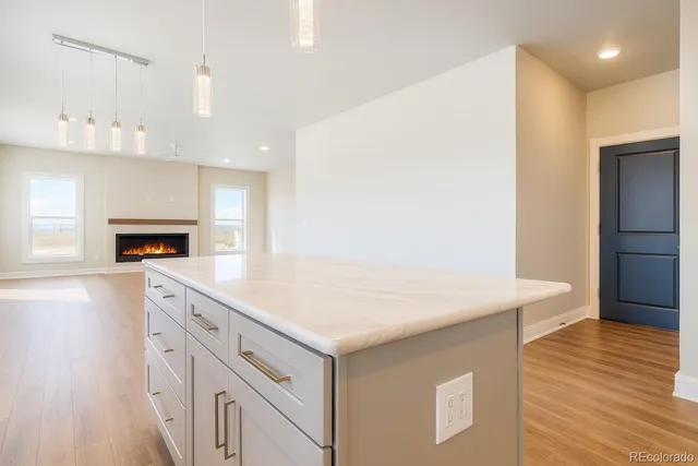 a kitchen with a sink dishwasher a stove and a refrigerator with wooden floor