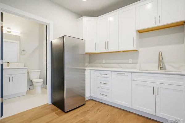 a kitchen with white cabinets and stainless steel appliances