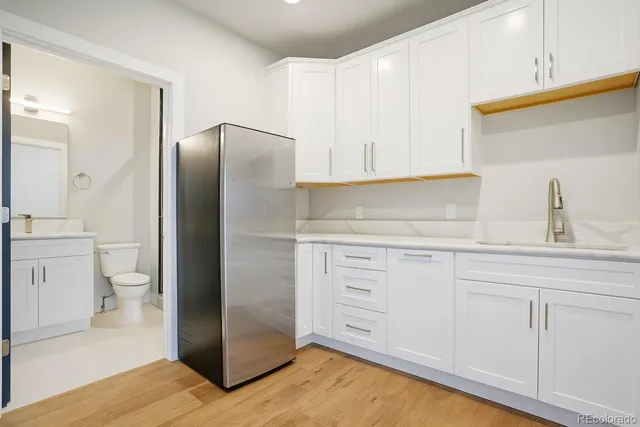 a kitchen with white cabinets and stainless steel appliances