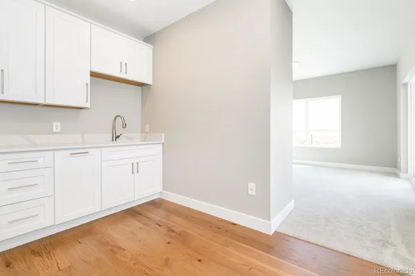 a view of a kitchen with white cabinets
