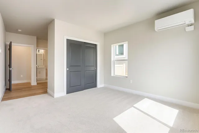 an empty room with windows and closet