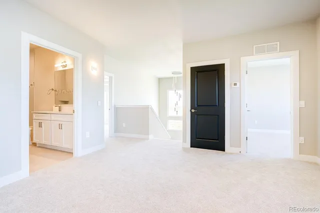 a view of empty room with a kitchen