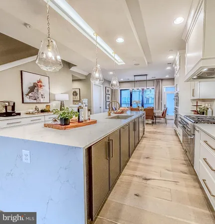 a kitchen with stainless steel appliances kitchen island granite countertop a sink and cabinets