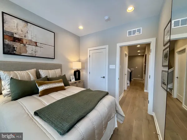 a bedroom with a bed and a painting on the wall