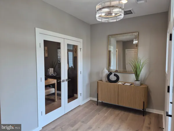 a living room with furniture and a chandelier