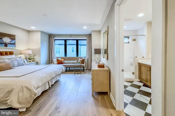 a bedroom with furniture and a large window