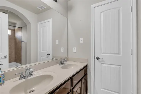 a bathroom with a sink double vanity and a mirror