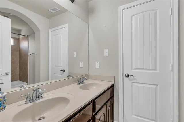 a bathroom with a sink double vanity and a mirror