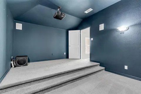 a view of an empty room with a ceiling fan