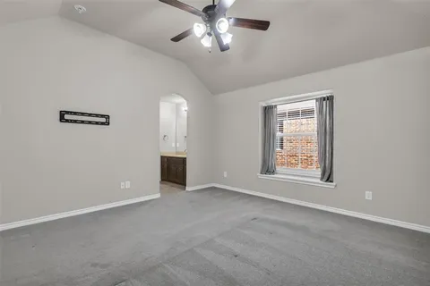 a patio with a table and chairs and potted plants