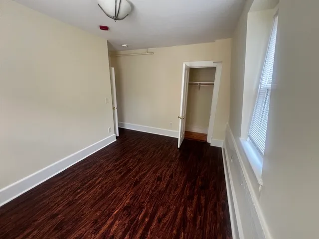 a view of a room with wooden floor and white walls