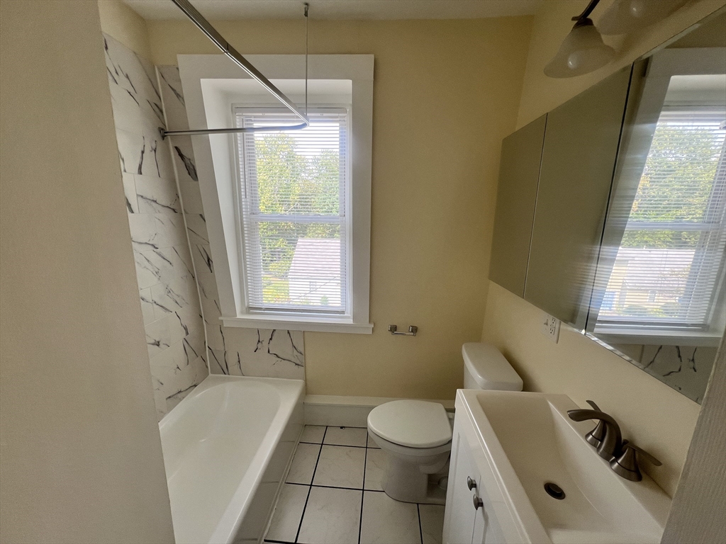 10 Centennial Place, Unit 2 Framingham, MA 01701 - Photo 9 of 12 a bathroom with a sink toilet and shower