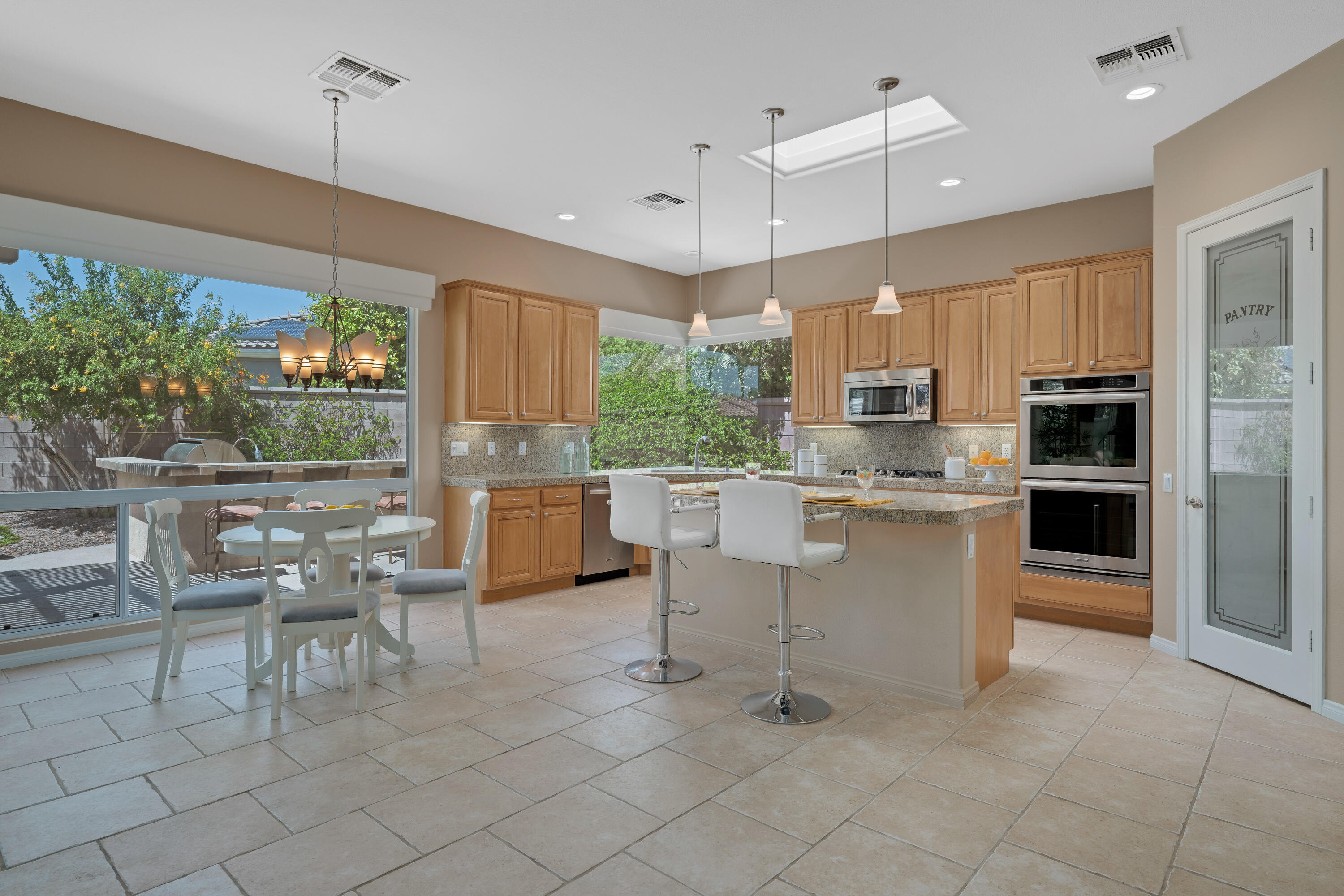 35691 Talus Lane Palm Desert, CA 92211 - Photo 20 of 39 a kitchen with cabinets and chairs