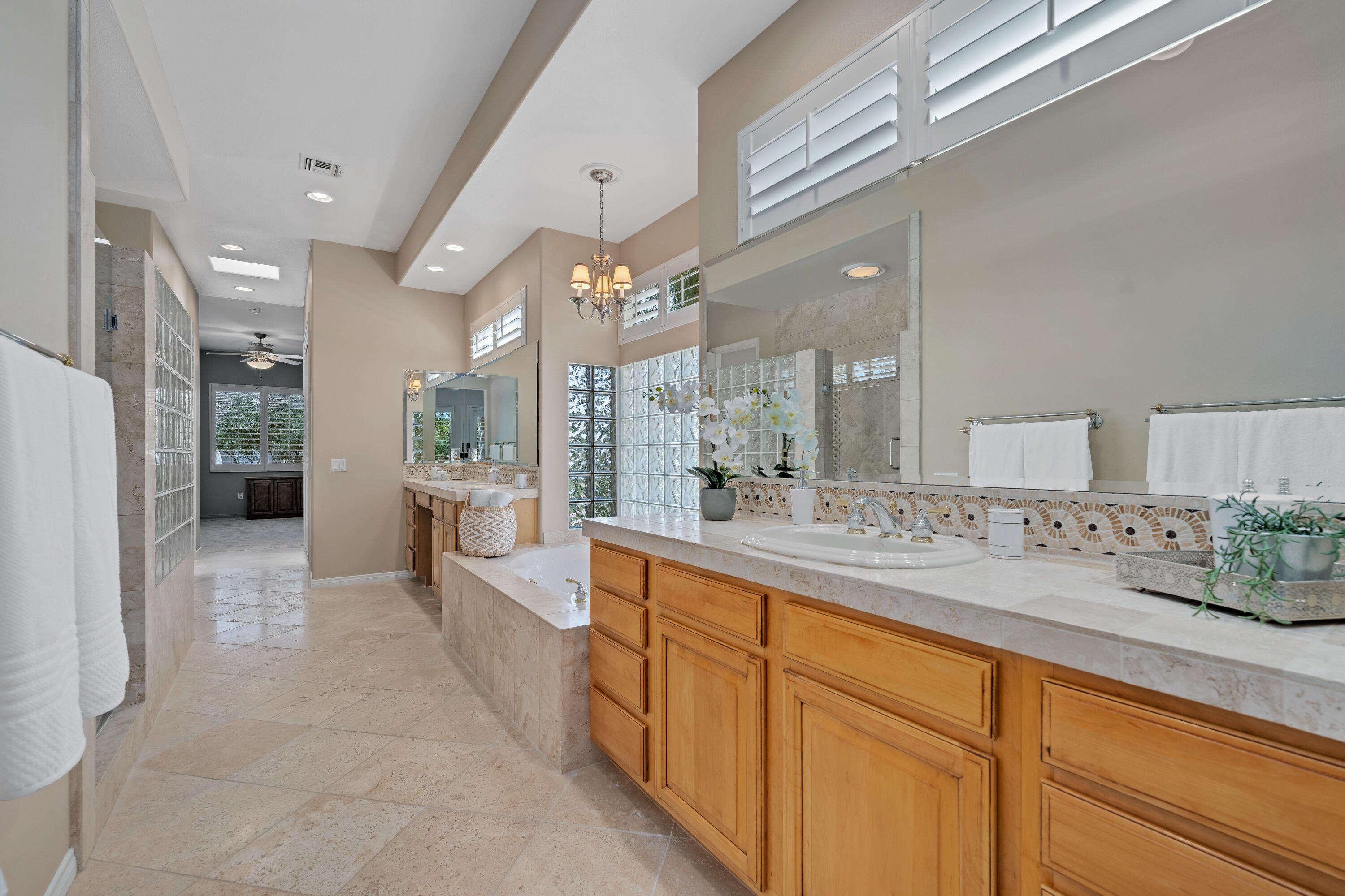 35691 Talus Lane Palm Desert, CA 92211 - Photo 27 of 39 a large white kitchen with a large window and stainless steel appliances