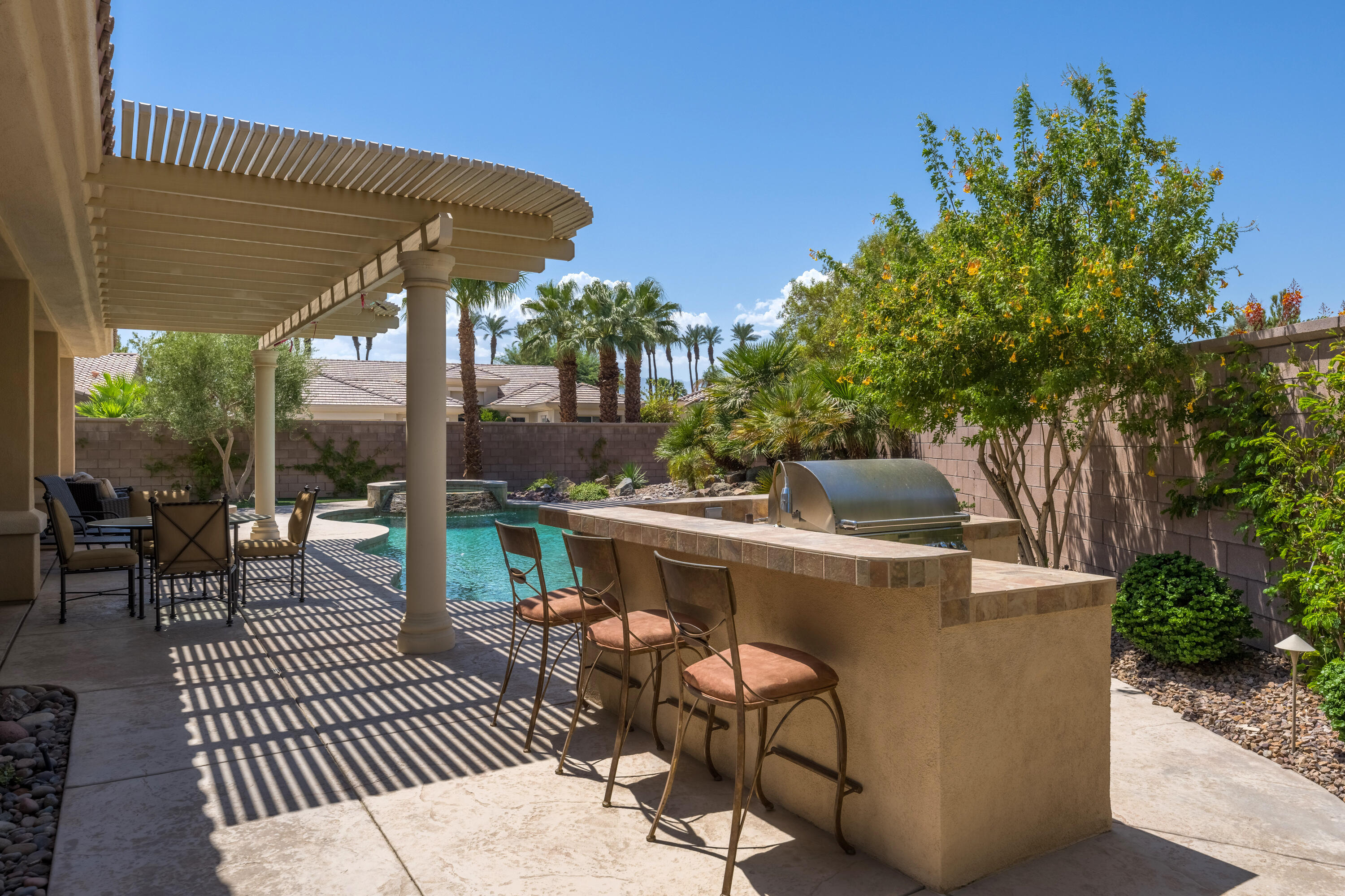 35691 Talus Lane Palm Desert, CA 92211 - Photo 3 of 39 a view of a patio with couches table and chairs and potted plants