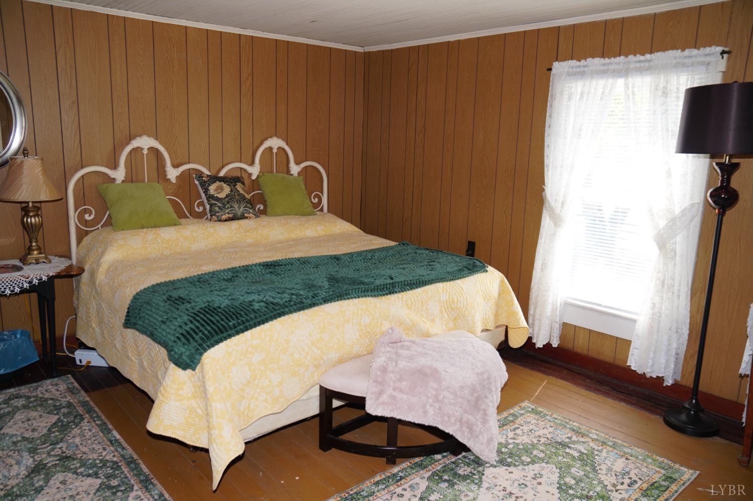 10188 Stage Coach Road Gretna, VA 24557 - Photo 19 of 56 a bed sitting in a bedroom next to a window