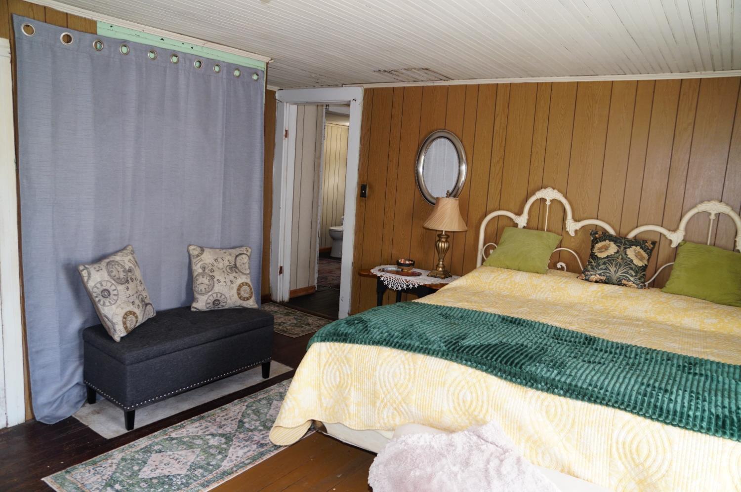 10188 Stage Coach Road Gretna, VA 24557 - Photo 20 of 56 a bedroom with a bed and painting on the wall