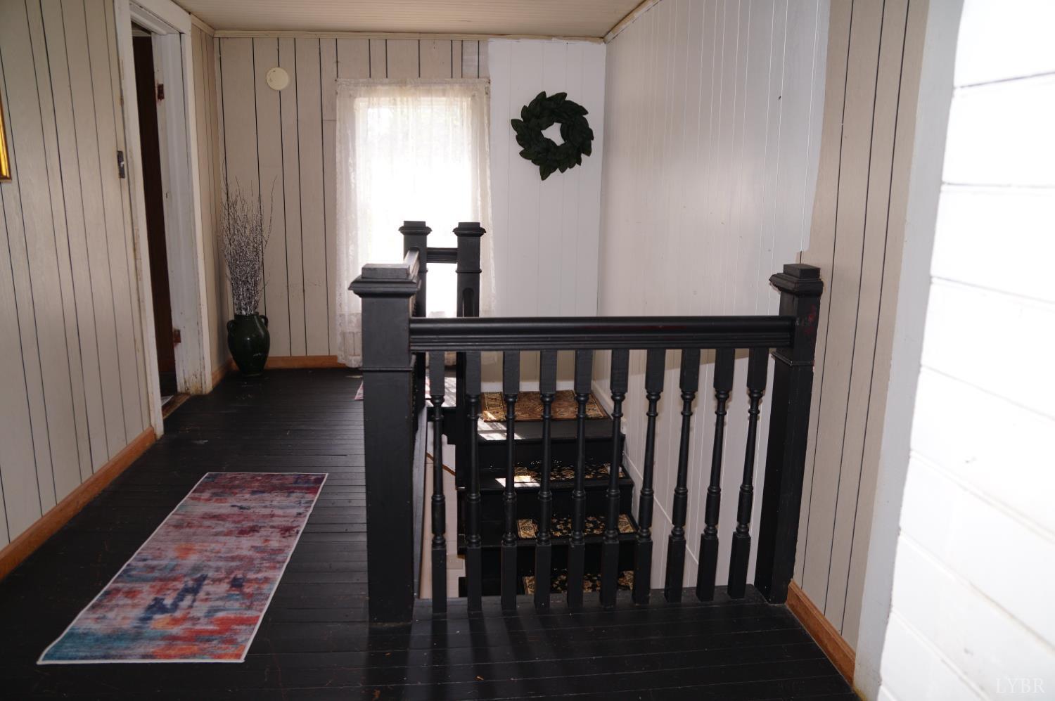 10188 Stage Coach Road Gretna, VA 24557 - Photo 22 of 56 a view of a hallway with wooden floor and stairs