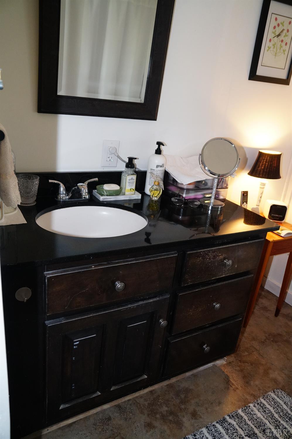 10188 Stage Coach Road Gretna, VA 24557 - Photo 25 of 56 a bathroom with a sink and a mirror