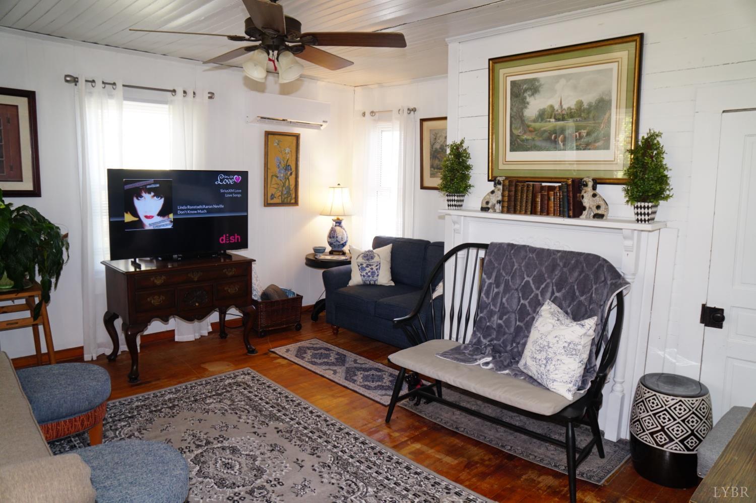 10188 Stage Coach Road Gretna, VA 24557 - Photo 3 of 56 a living room with furniture and a fireplace