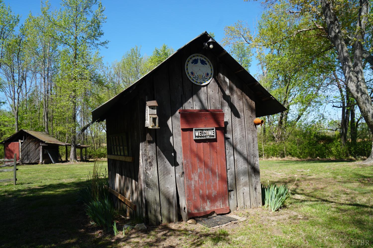 10188 Stage Coach Road Gretna, VA 24557 - Photo 40 of 56 a view of a wooden house with a yard