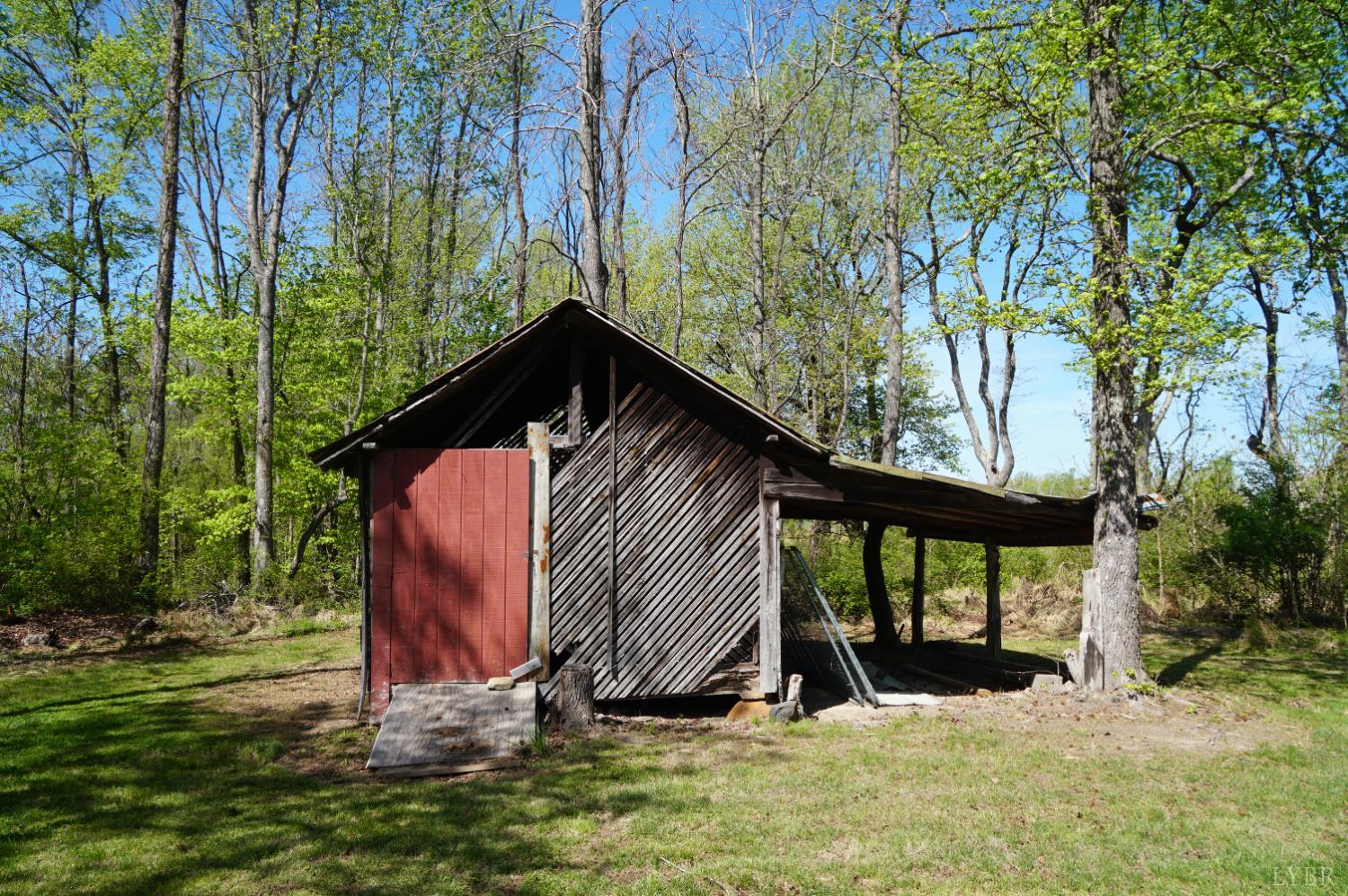 10188 Stage Coach Road Gretna, VA 24557 - Photo 42 of 56 a view of backyard with a barn and a large tree