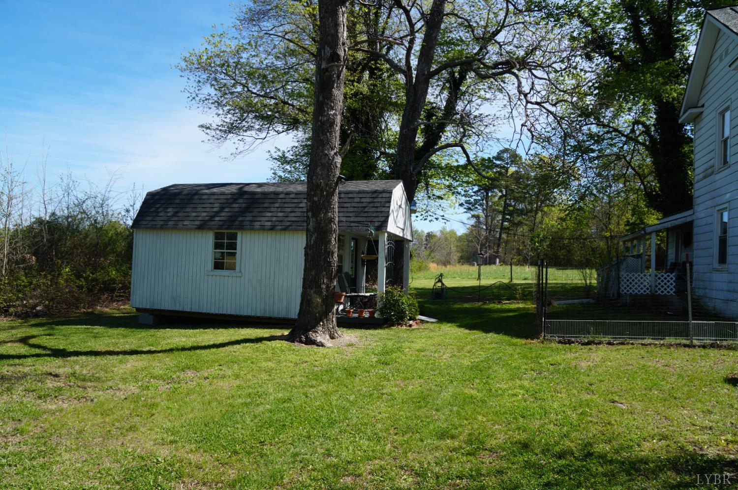 10188 Stage Coach Road Gretna, VA 24557 - Photo 50 of 56 a view of a small house in front of a big yard with large trees