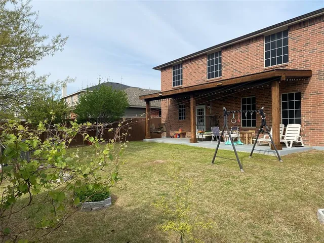 a view of a house with backyard porch and sitting area