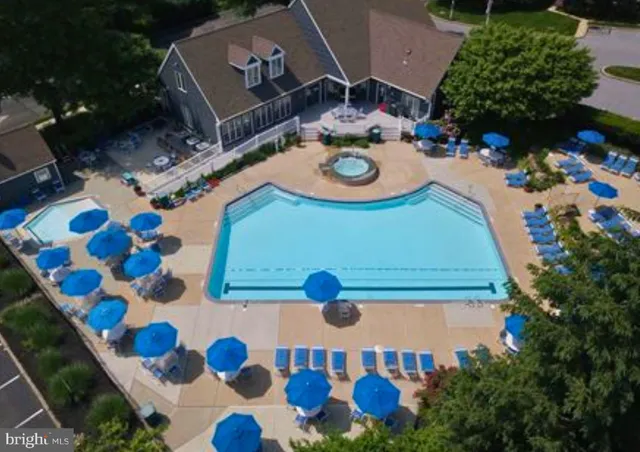 an aerial view of a house patio swimming pool and outdoor seating