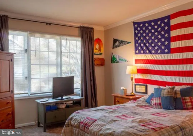 a bedroom with a bed and a television