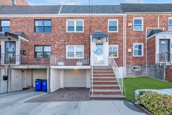 a front view of a brick house with a yard