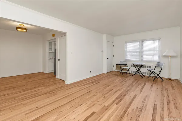 a view of a room with wooden floor and furniture