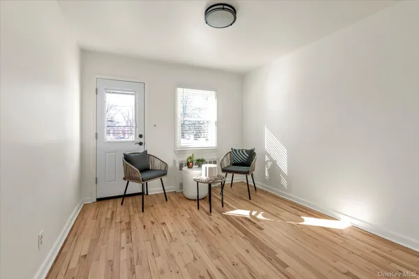 a workspace room with wooden floor and lounge chair