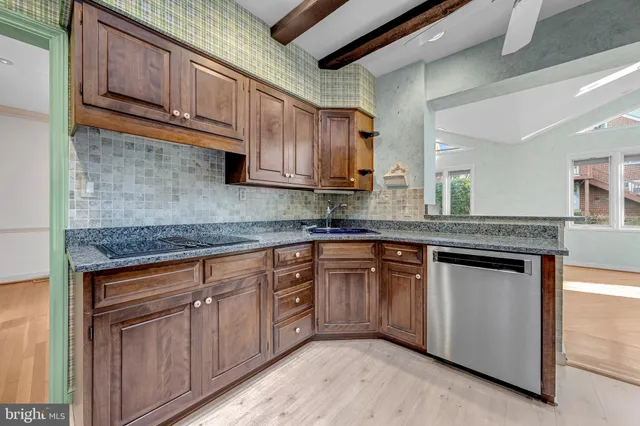 a kitchen with stainless steel appliances granite countertop a sink stove and cabinets