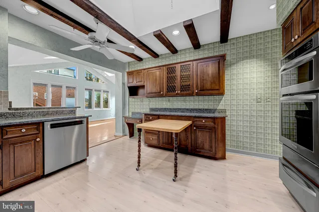 a kitchen with stainless steel appliances granite countertop a stove and a sink