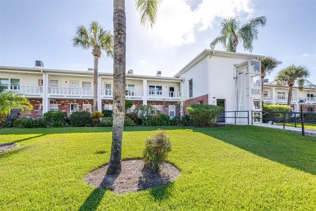 a front view of house with yard and swimming pool