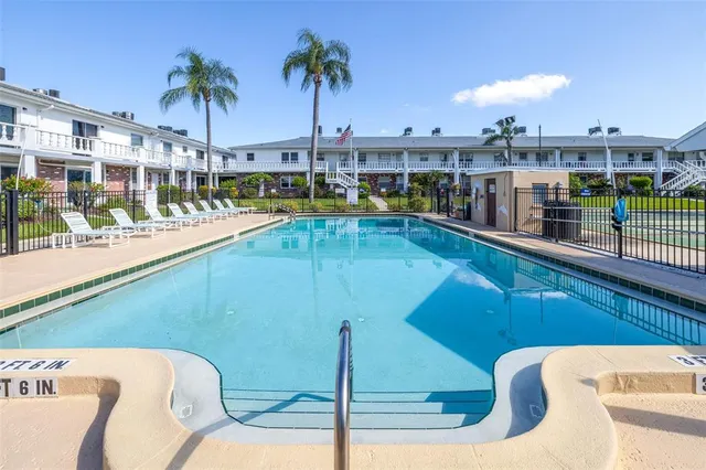 a view of a swimming pool with outdoor seating