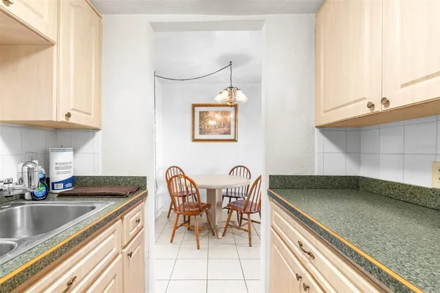 a kitchen with a sink cabinets and dining table chair