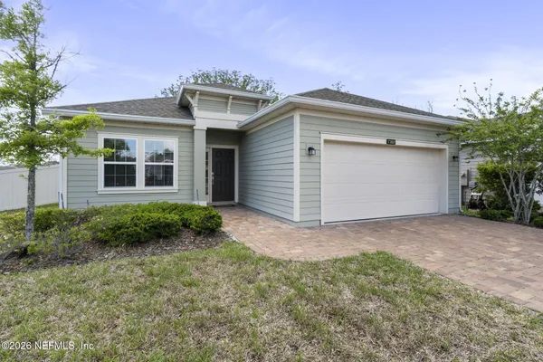a view of a house with a yard and garage