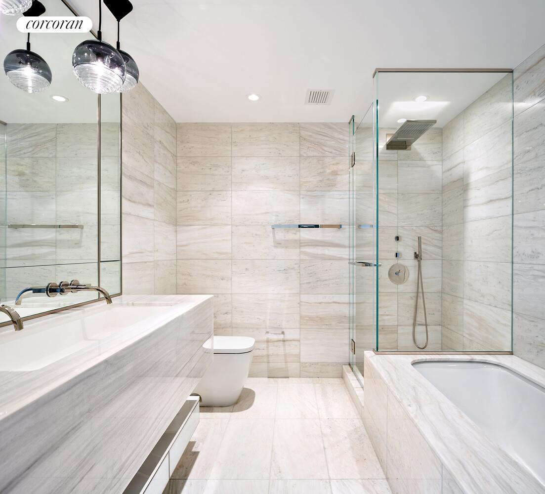 135 West 52nd Street, Unit 31B Manhattan, NY 10019 - Photo 5 of 9 a bathroom with a granite countertop bathtub sink vanity mirror and toilet