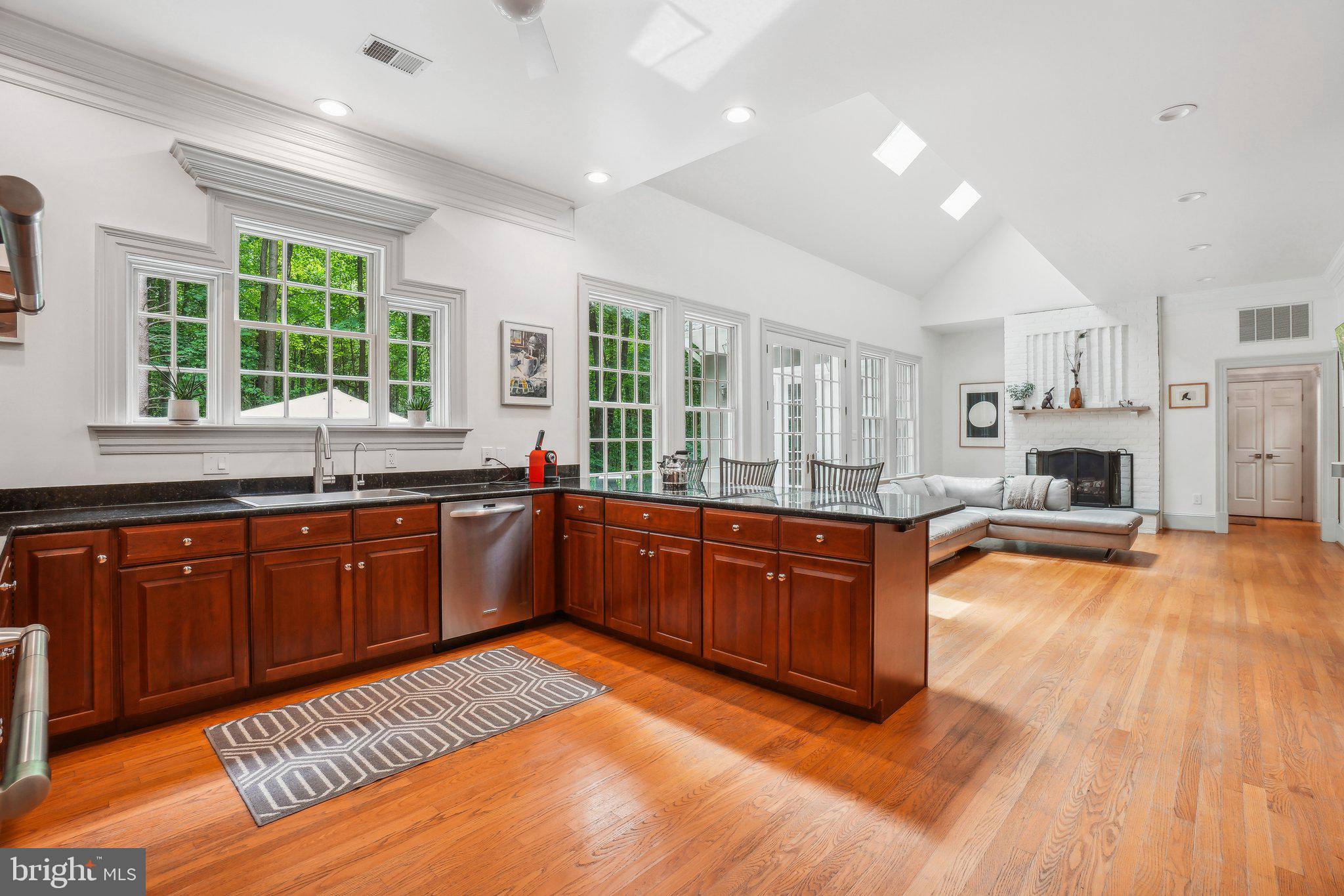 8683 Reservoir Road Fulton, MD 20759 - Photo 19 of 60 a kitchen with stainless steel appliances granite countertop wooden floors and view of living room