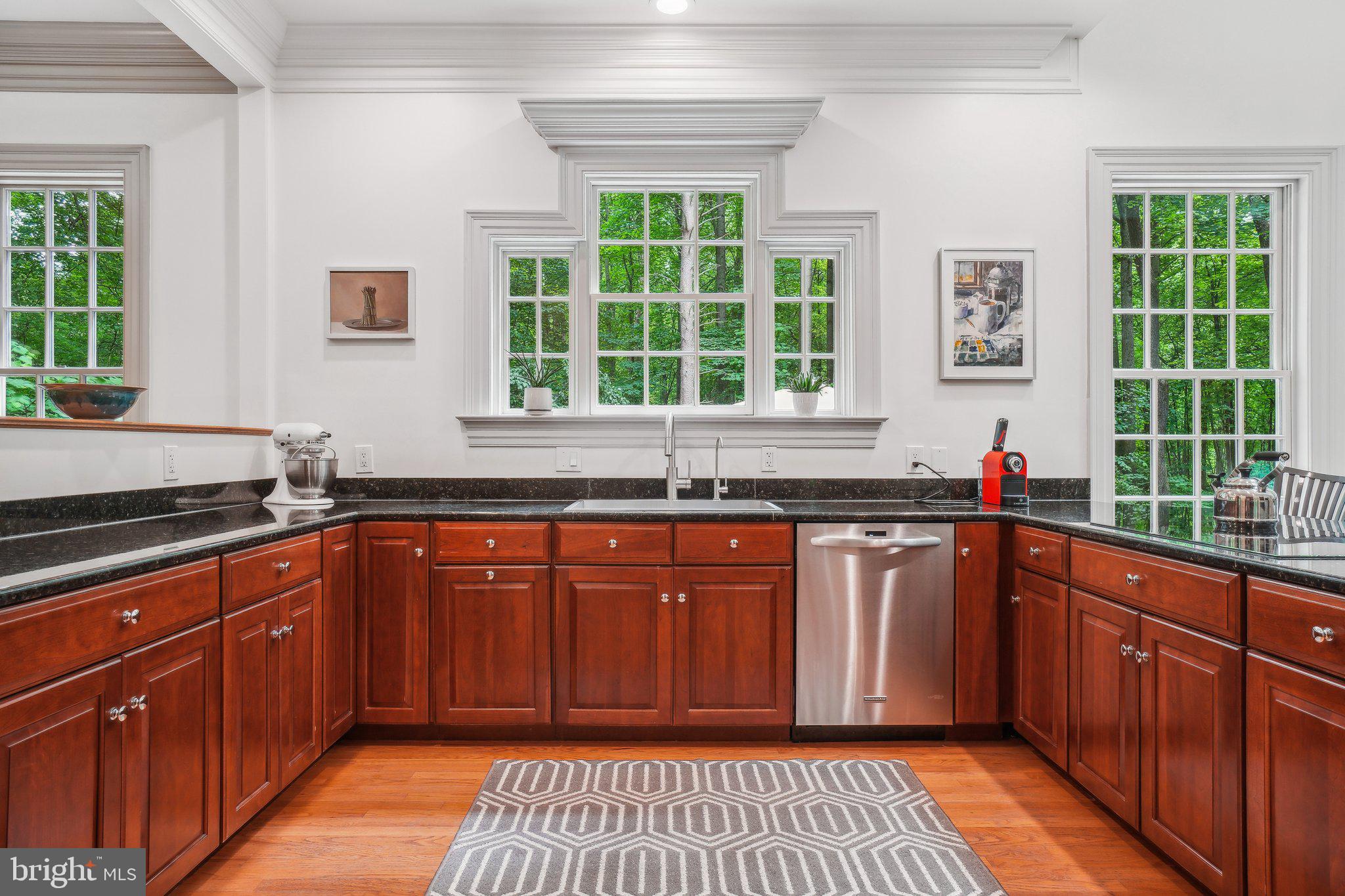 8683 Reservoir Road Fulton, MD 20759 - Photo 21 of 60 a kitchen with granite countertop wooden cabinets a sink and a window
