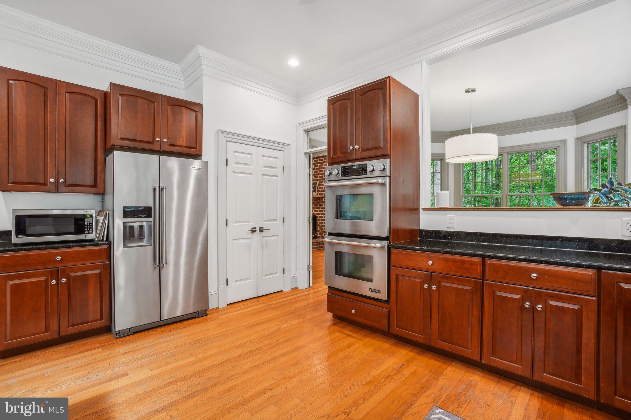 8683 Reservoir Road Fulton, MD 20759 - Photo 22 of 60 a kitchen with stainless steel appliances granite countertop a refrigerator and a stove top oven
